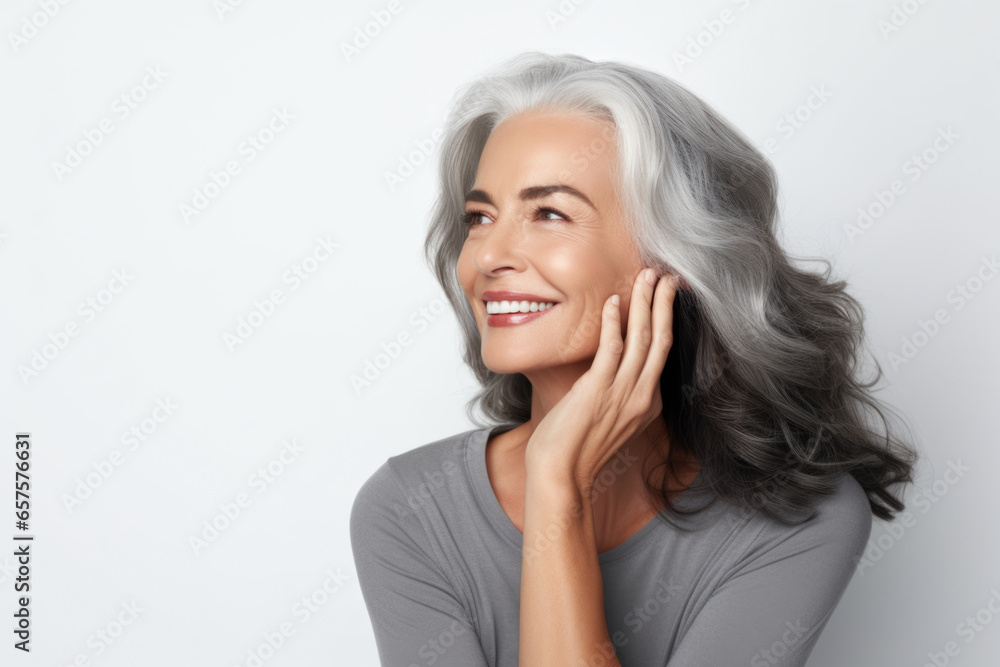 Portrait of a beautiful ageing mature woman with long grey hair. Healthy face and skin care beauty, cosmetics, cosmetology concept. Portrait of a beautiful ageing mature woman with long grey hair. Healthy face and skin care beauty, cosmetics, cosmetology concept.