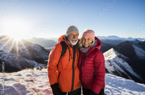 Active old age. An elegant middle-aged elderly couple, leads an active lifestyle. They smile while hiking , enjoying the beauty of nature during their active retirement. Love story.