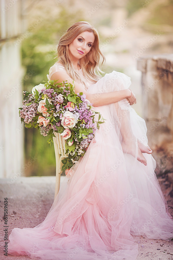 beautiful tender blonde among flowers.spring mood.tender girl in a beautiful airy dress beautiful tender blonde among flowers.spring mood.tender girl in a beautiful airy dress