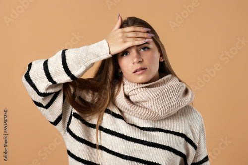 фотографія Young woman in wool sweater suffering from headache