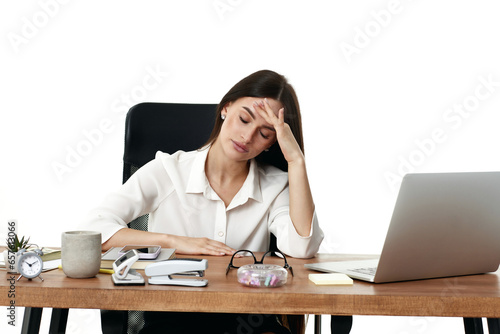 sad woman have a headache, using laptop in office