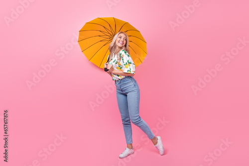 Full body photo of cute young girl hold orange umbrella looking empty space love story another couple isolated on pink color background