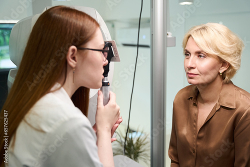 Young ophthalmologist working with a patient photo