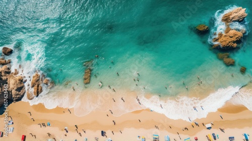 Fototapeta Naklejka Na Ścianę i Meble -  Aerial shot of a crowded beach with swimmers enjoying the waves