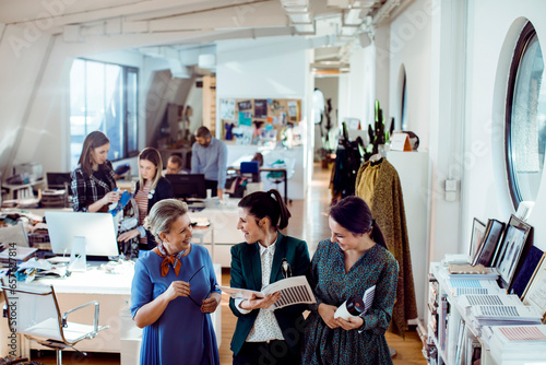 Young group of female fashion designers working on a project together in a design firm