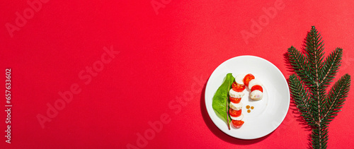 Caprese salad in form of a Christmas candy cane. Traditional New Year design, festive decoration © FuzullHanum