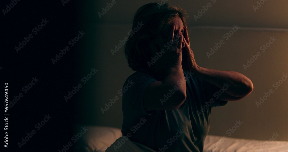 Senior woman getting up from bed at night. Tired person waking up at dawn Senior woman getting up from bed at night. Tired person waking up at dawn