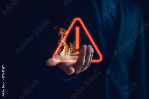 Hand showing red triangle caution warning sign for maintenance notification error and risk concept, protecting data personal information on social network. privacy data security, risk management