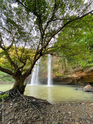 Sodong Waterfall located in Ciwaru Village, Ciemas District, Sukabumi Regency. One of several waterfalls which is a mainstay destination in the Ciletuh Unesco Unesco Global Geopark (CPUGGp).  photo