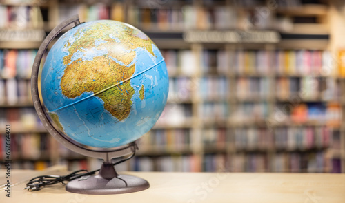 A globe as school equipment placed on a shelf in the school library. photo