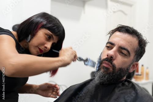 Stylish Female Hairdresser Applying Beard Dyeing To Client_3.JPG