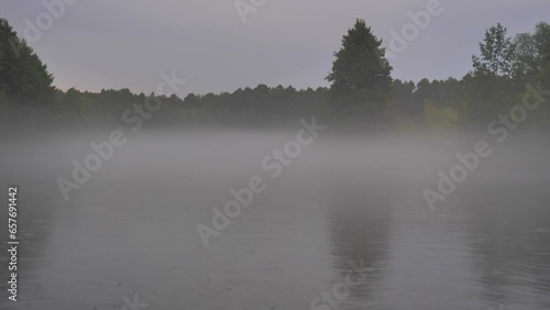 Unique turquoise karst lake near city of Kazan, Russia. Rainy morning scenery at the lake with mist over the surface