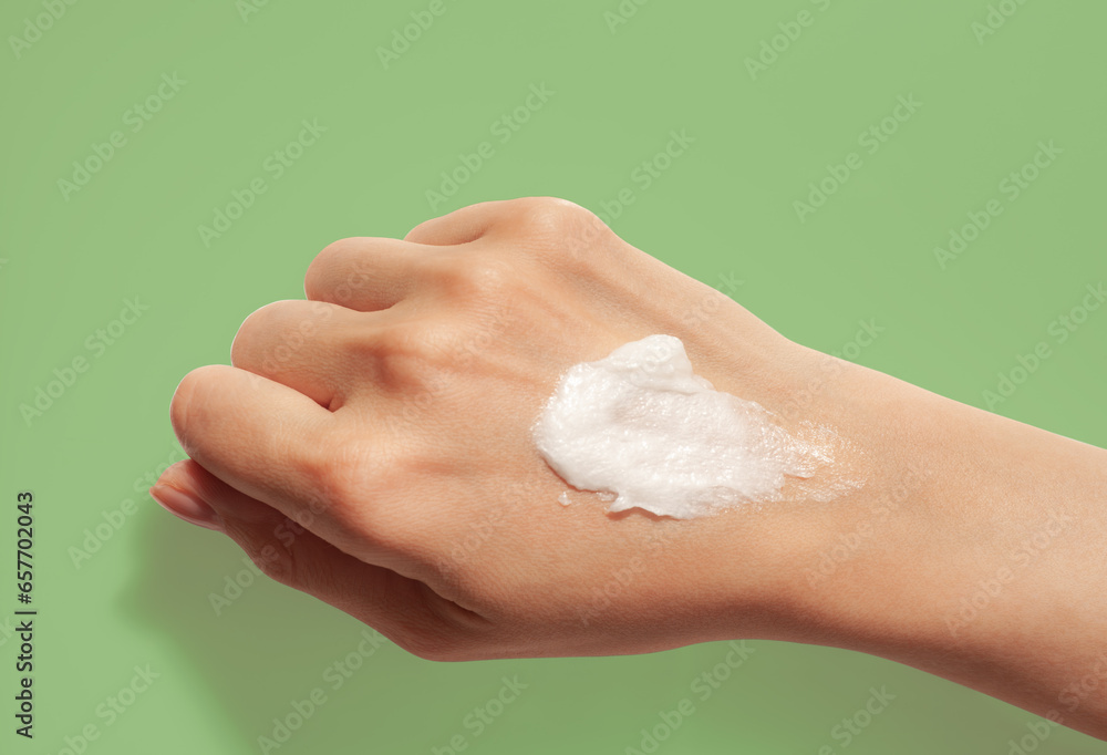 Cosmetic smudge swatch face cleansing foam or gel on woman hand Cosmetic smudge swatch face cleansing foam or gel on woman hand
