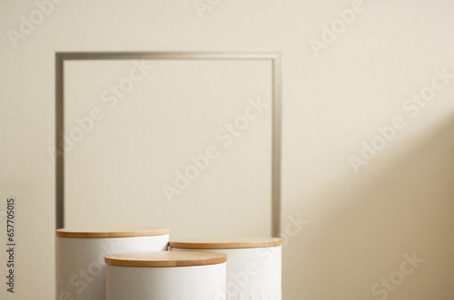 Minimal wood white podium with blurred golden frame on gold beige background.Beauty cosmetic new product modern display,luxury celebrate concept.