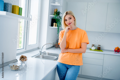 Photo of smart girl standing in kitchen thinking about renovation restoration modern kitchen