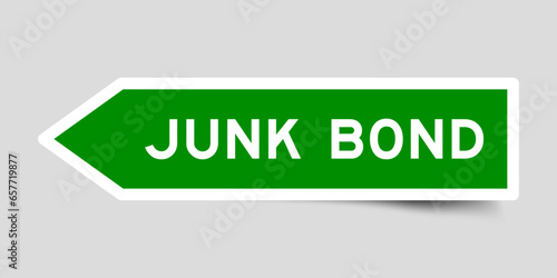 Green color arrow shape sticker label with word junk bond on gray background