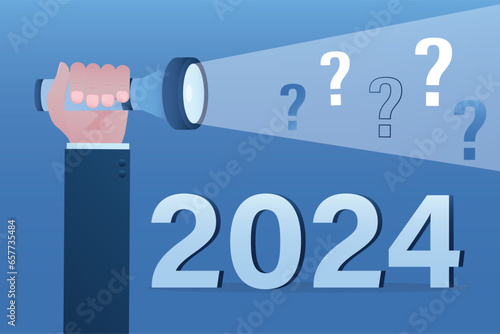 Forecasting and many questions, economic prospects in 2024. Visionary illuminates future. Businessman hand uses flashlight for lighting way and 2024 year.