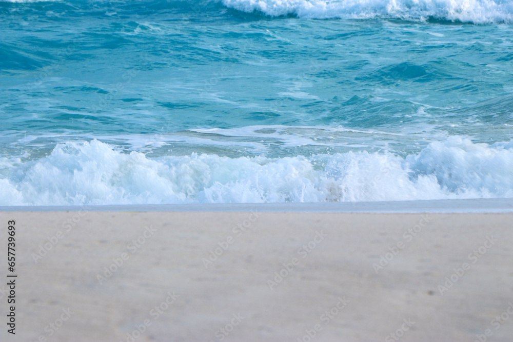 Blue and aquamarine color sea waves and yellow sand with white foam. Marine beach background. Banner format.Tropical Beach Beautiful sea summer spring sand beach blue ocean 