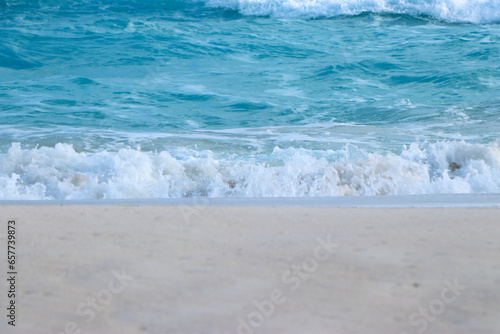 Blue and aquamarine color sea waves and yellow sand with white foam. Marine beach background. Banner format.Tropical Beach Beautiful sea summer spring sand beach blue ocean 