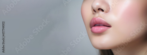 healthy human lips with pink glossy and shiny lipstick , a Skincare and beauty and a cosmetic concept