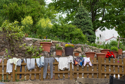 various clothes drying on a fence in a garden in the village 