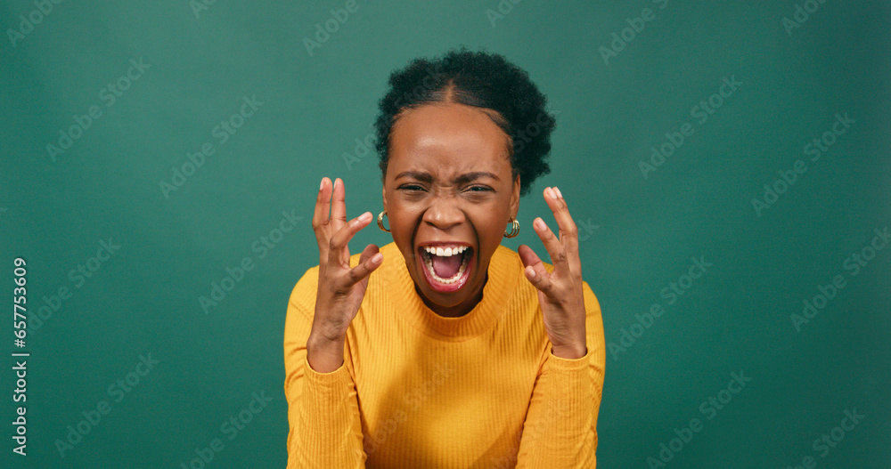 Angry woman screams and yells with hand gestures, green studio