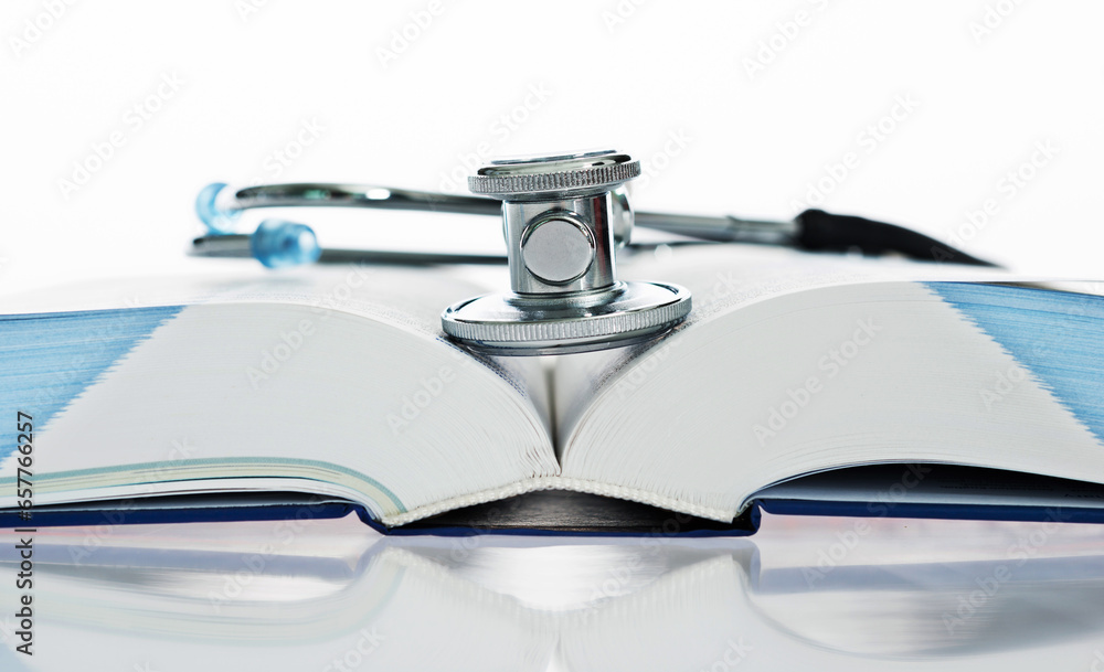 Stethoscope on a book isolated on white background Stethoscope on a book isolated on white background