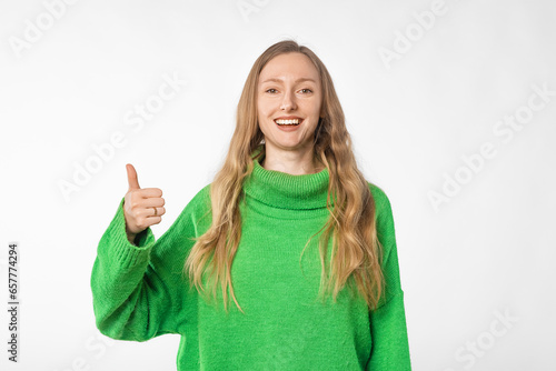 Wallpaper Mural Portrait of happy woman showing thumb up, recommends smth good, approve and like brand or company, standing in green cozy sweater over white background Torontodigital.ca