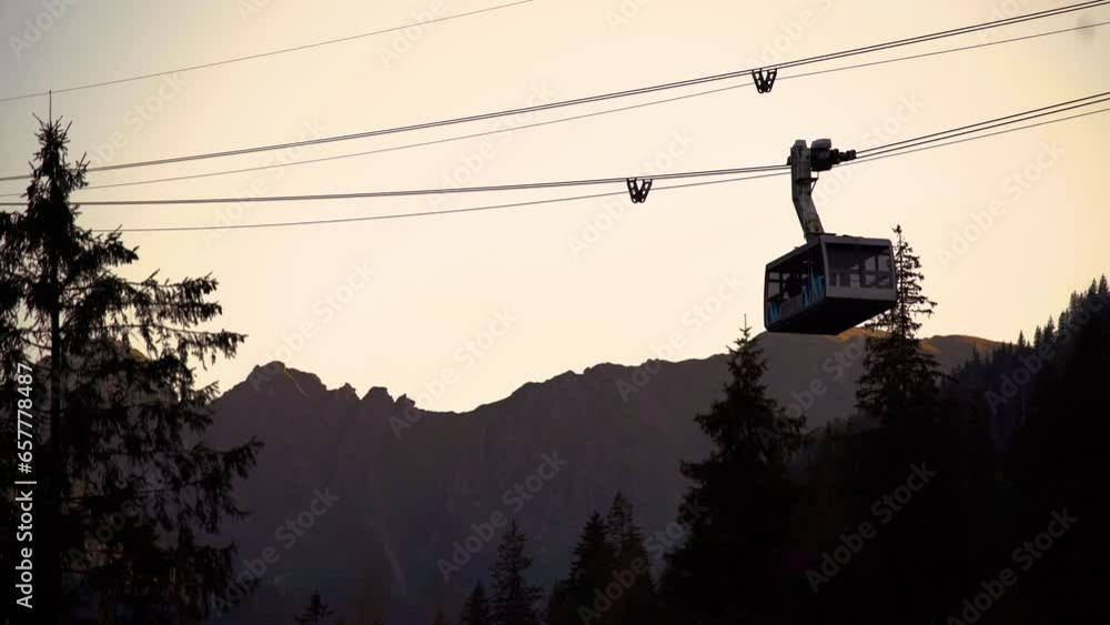 Cable Car Passing By Sunset. Funicular at sunset. A cabin cable car travels up a mountain in summer. Cable Car Passing By Sunset. Funicular at sunset. A cabin cable car travels up a mountain in summer.