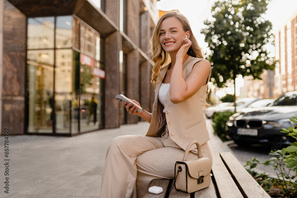 woman sitting in city street with phone