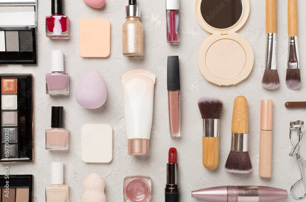 Flat lay with makeup products and tools on concrete background Flat lay with makeup products and tools on concrete background