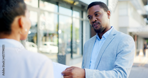Consulting, insurance and businessman or salesman talking to a client about a deal in a city. Advice, communication and African agent with a conversation in the street with a customer for retail