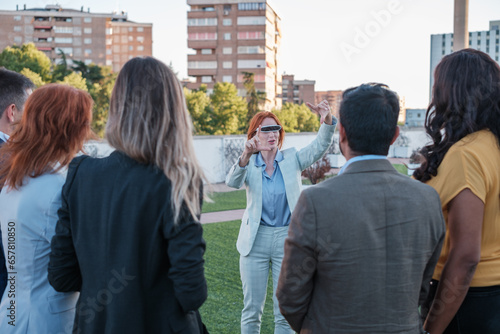 Worker representing her colleagues using virtual reality on the company terrace. Concept: business, technology, investment © Ivan