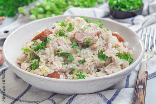 Obraz na plátne Homemade South Carolina chicken bog dish with smocked sausages, in bowl, horizon