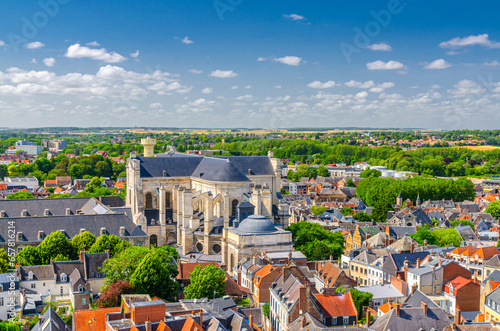 Aerial panoramic view of Arras city historical town centre, Arras Cathedral of Our Lady and Saint Vaast catholic church, green parks and fields on horizon, blue sky, Pas-de-Calais department, France photo