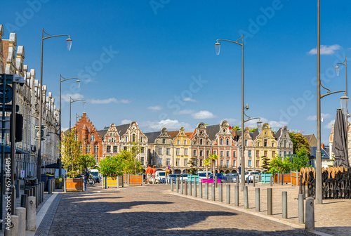 Arras cityscape with Flemish-Baroque-style townhouses buildings on La Grand Place square in old town center, blue sky in summer day, Pas-de-Calais department, Hauts-de-France Region, Northern France photo