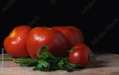 Red tomatoes on a dark background on the table