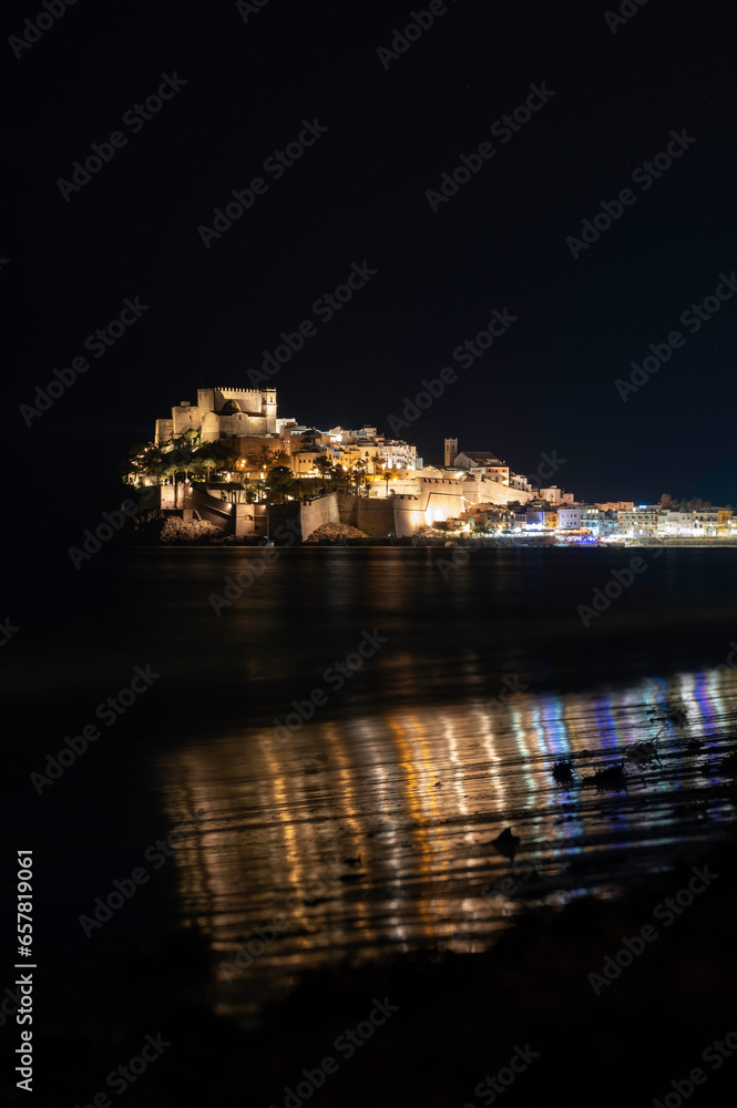 Night image of the illuminated old town, wall and castle of Peñíscola, Peniscola, Spain, on the Mediterranean Sea.