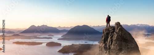 Adventure Man Hiker standing on top of Rocky Cliff. 3d Rendering Peak. Mountain Aerial Landscape Background from BC, Canada.
