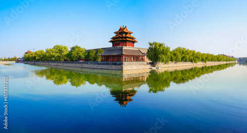 View of the Forbidden City with the reflection on the moat on a sunny day in Beijing, China. © Javen