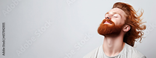 Men's Grooming Mastery: Studio Shots of a Muscular Ginger Man with Windy Hair and Beard with Copy-Space