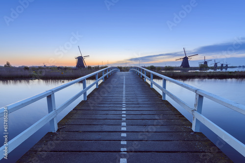 Wooden Bridge with Windmills at Dawn, Kinderdijk, South Holland, Netherlands photo