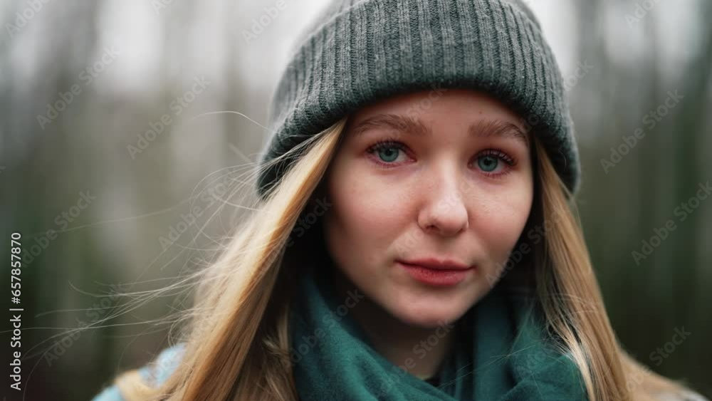 Beautiful girl in forest. Portrait of young woman on nature outdoors in warm hat in autumn. Cute and shy female looks down in embarrassment and smiles. Walking at leisure, rest and relax in solitude. Beautiful girl in forest. Portrait of young woman on nature outdoors in warm hat in autumn. Cute and shy female looks down in embarrassment and smiles. Walking at leisure, rest and relax in solitude.