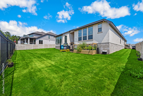 a back yard with aa green lawn 