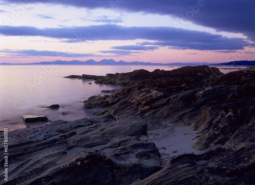Sunset Over The Paps Of Jura From The Rocky Shores Of The Kintyre Peninsula; Kintyre, Argyll, Scotland