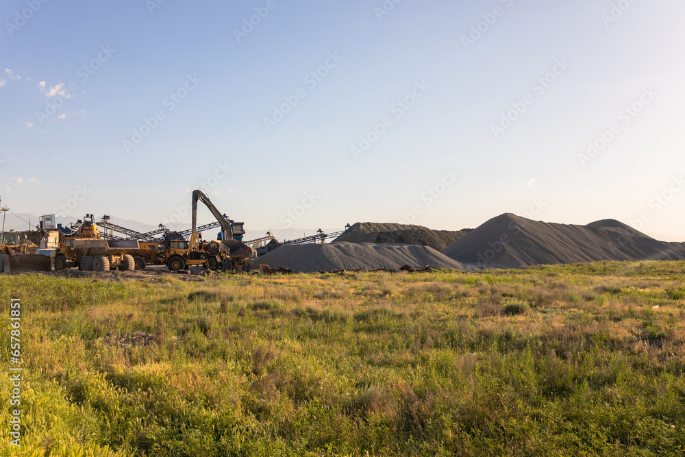 Fototapeta premium Heavy equipment works at a sand processing quarry