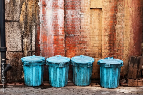 Canvas Print Garbage Cans Lined Up Along A Wall In An Alley; Tokyo, Japan
