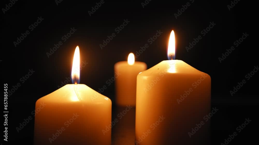 Three Candles Burn with a Soft Yellow Flame in the Dark and are Extinguished by the Wind. Slow Motion. Three Candles Burn with a Soft Yellow Flame in the Dark and are Extinguished by the Wind. Slow Motion.