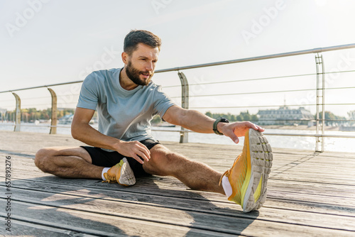 Motivation fitness exercises warm-up stretching squats. Man training mental and physical health.  Activity daily interval training.