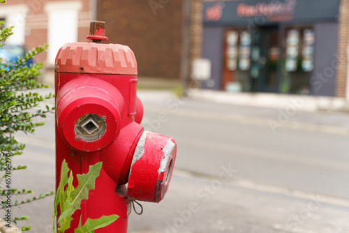 Red fire hydrant on a city street, for emergency access in case of fire. photo